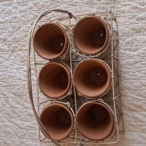 Wire basket holding 6 clay pots for plant or herbs